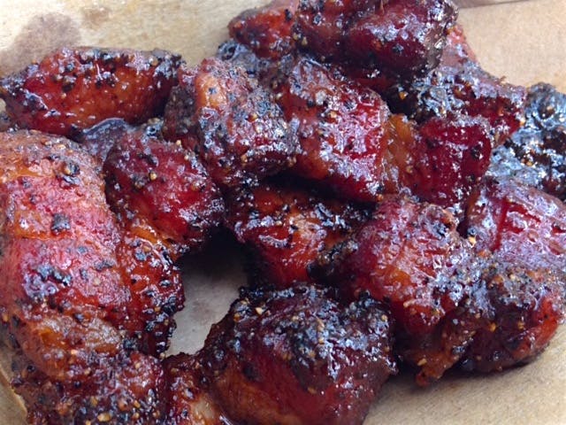 Heim Barbecue signature dishes Bacon Burnt Ends, Beef Brisket, Pork Ribs, House-Made Sausage, Twice-Baked Potato Salad.